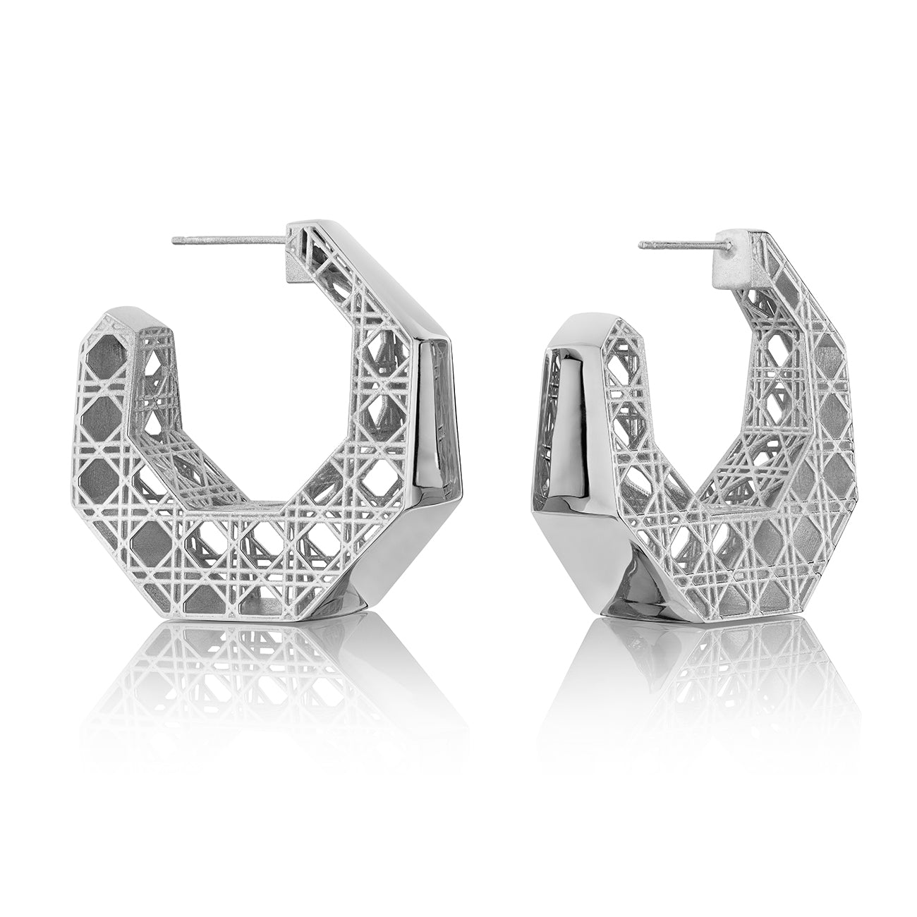 MoAnA LUU Doudou hoop earrings in silver, featuring a cane-woven work inspired by traditional Caribbean fish traps, reflecting the house’s vision of Creole-inspired jewelry crafted in New York.