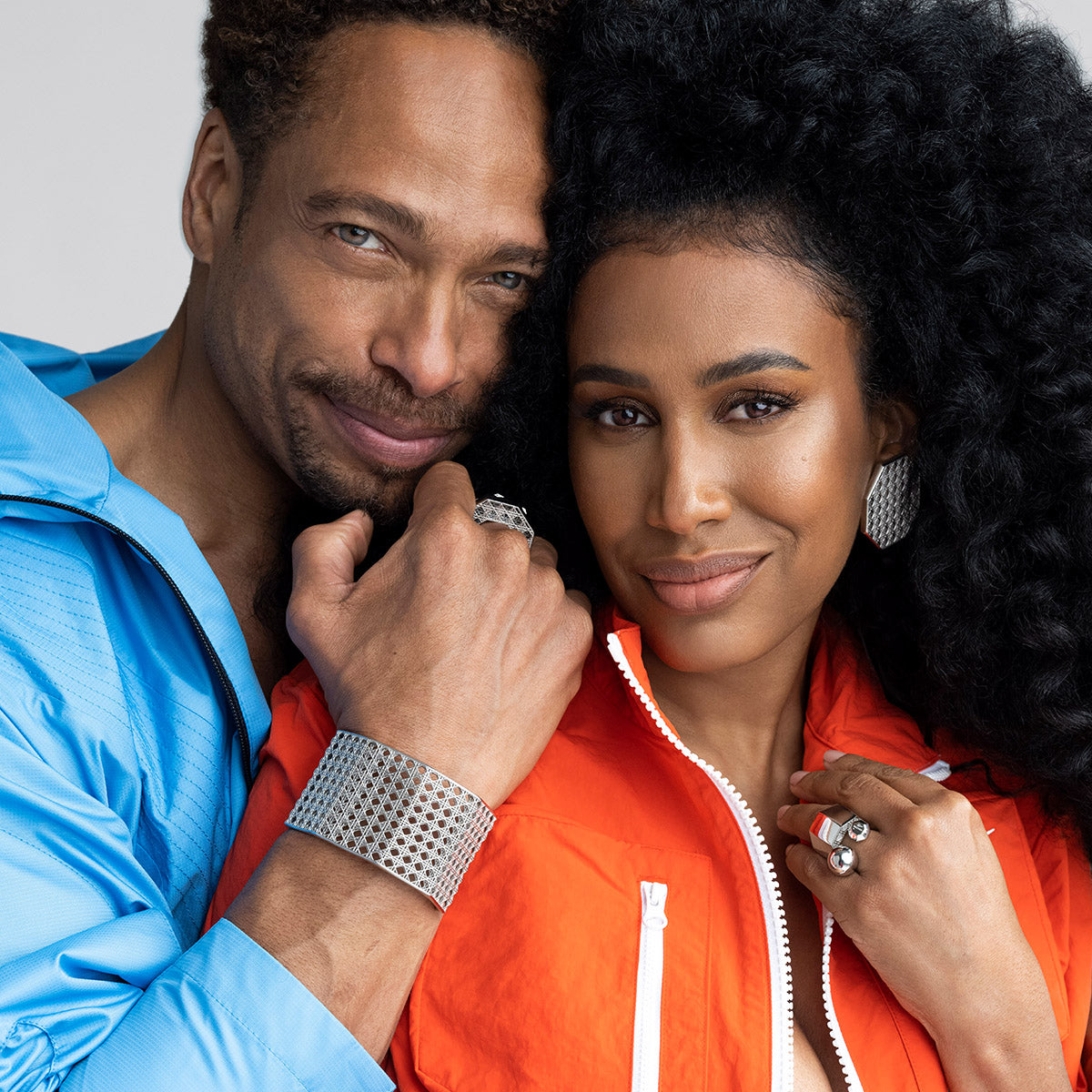 Gary Dourdan and MoAnA LUU wearing MoAnA LUU Doudou cuff, rings and earrings in silver featuring a cane-woven work inspired by traditional Caribbean fish traps, reflecting the house’s vision of Creole-inspired jewelry crafted in New York.
