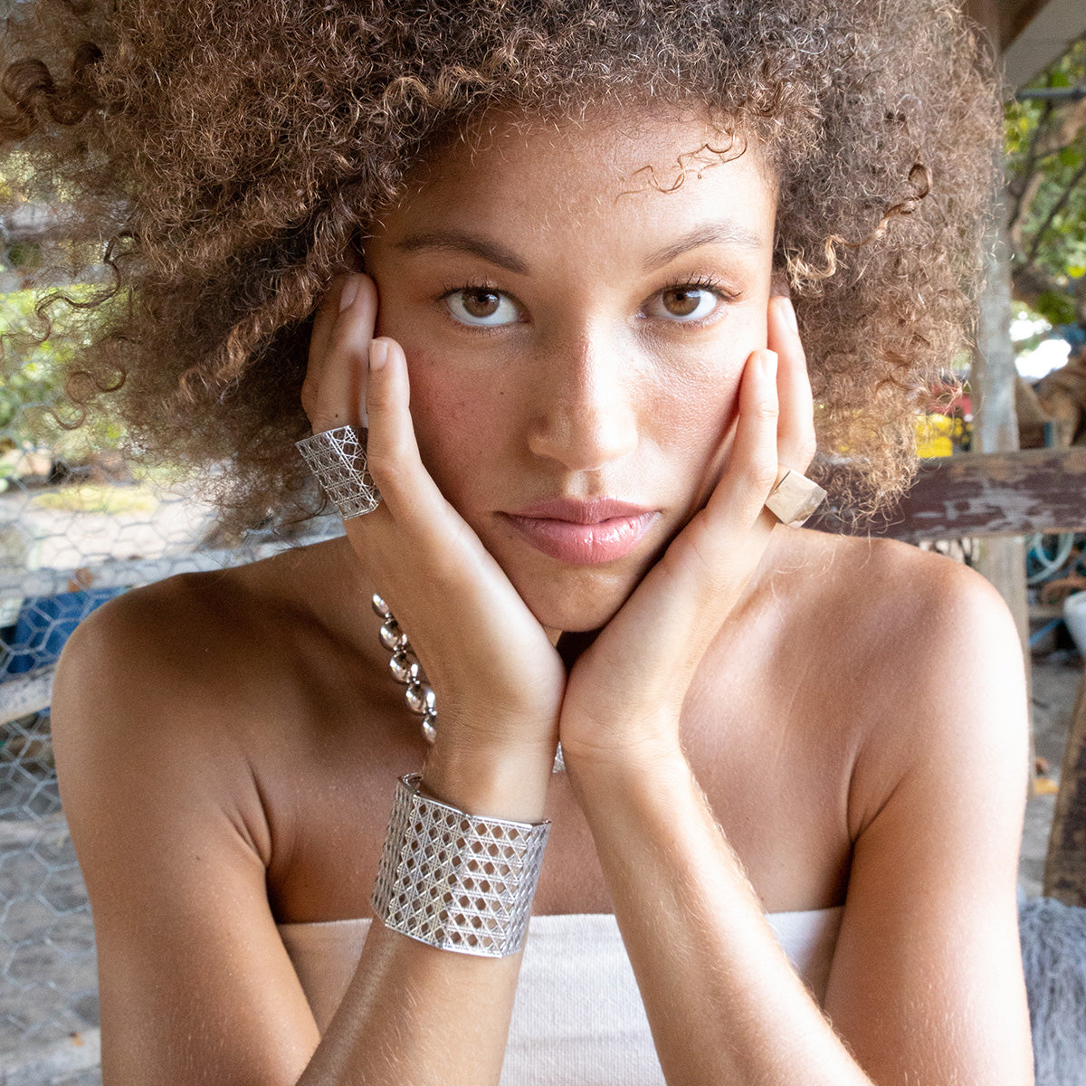 Model wearing MoAnA LUU Doudou cuff and maxi ring, ML embossed ring and beads necklace in Silver. Made in New York City.