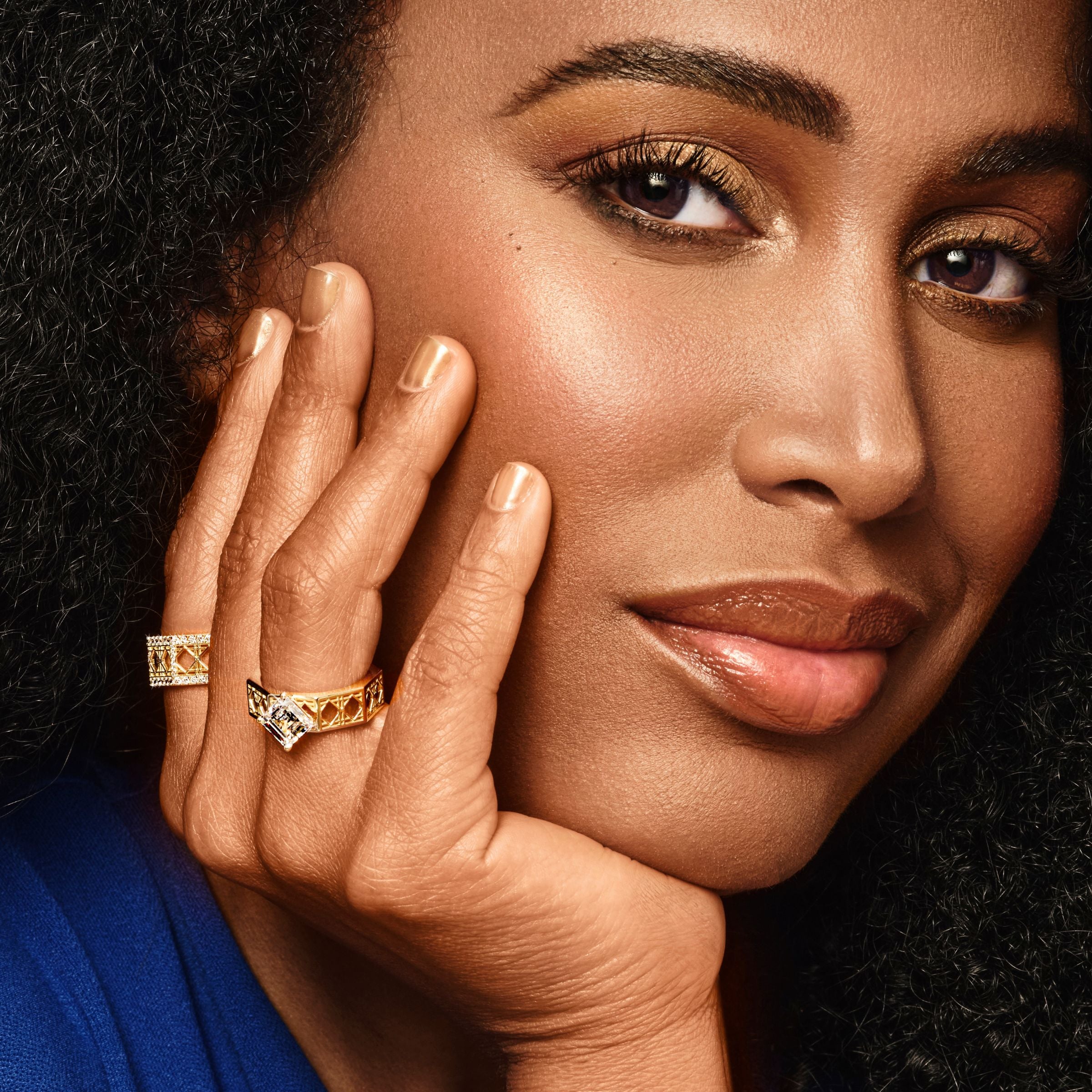 MoAnA LUU wearing MoAnA LUU Doudou rings in 18K yellow gold, featuring geometric woven openwork design inspired by Caribbean fish traps.