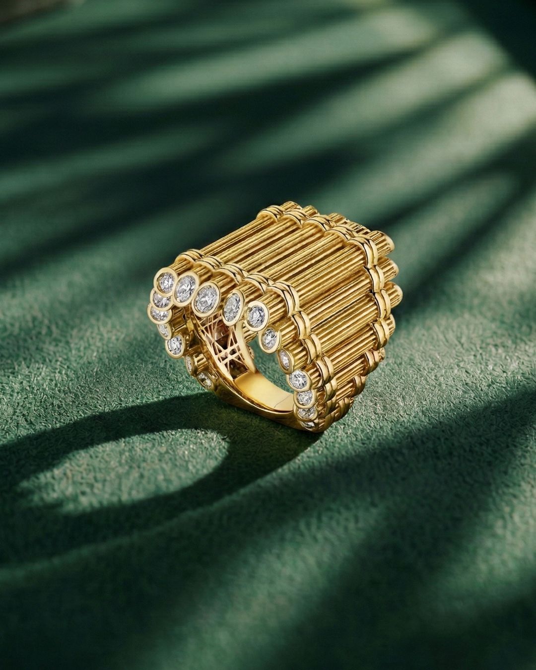 MoAnA LUU Eritaj Archive No.1 Fago Kann ring in 18K gold and diamonds, a sculptural interpretation of bundled cane forms rooted in Creole heritage on green background