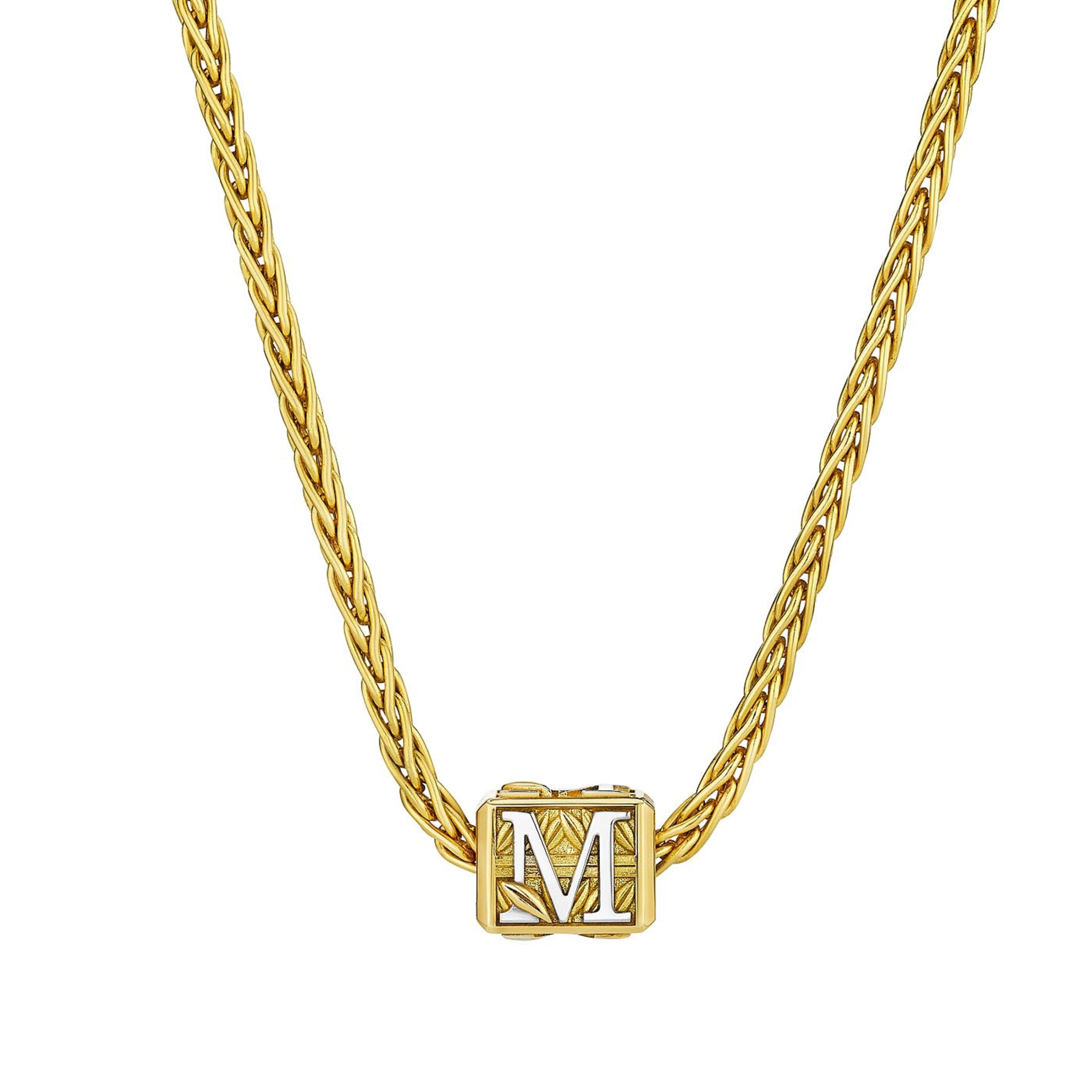 MoAnA LUU Foyal bead necklace in 18K yellow gold, featuring a wheat chain and  “M” letter charm inspired by Creole architectural design.