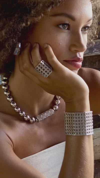 Model wearing MoAnA LUU Doudou cuff and maxi ring, ML embossed ring and beads necklace in Silver. Made in New York City.