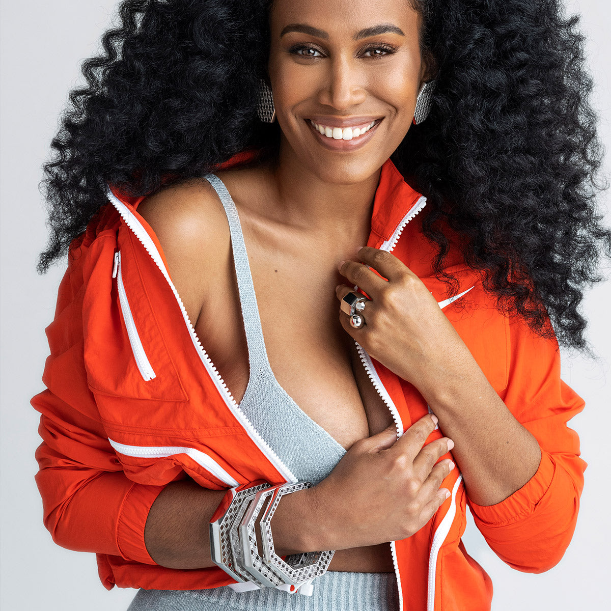 MoAnA LUU wearing MoAnA LUU Doudou bangle bracelet, earrings and rings in silver, featuring a cane-woven work inspired by traditional Caribbean fish traps, reflecting the house’s vision of Creole-inspired fine jewelry crafted in New York.