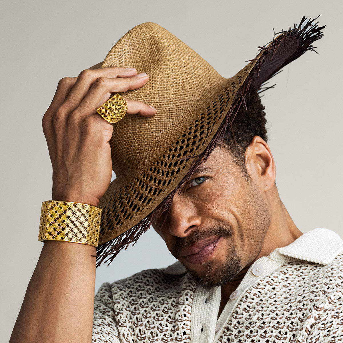 Gary Dourdan wearing MoAnA LUU Doudou Maxi ring and cuff bracelet 18K yellow gold, featuring a cane-woven work inspired by traditional Caribbean fish traps, reflecting the house’s vision of Creole-inspired fine jewelry crafted in New York.