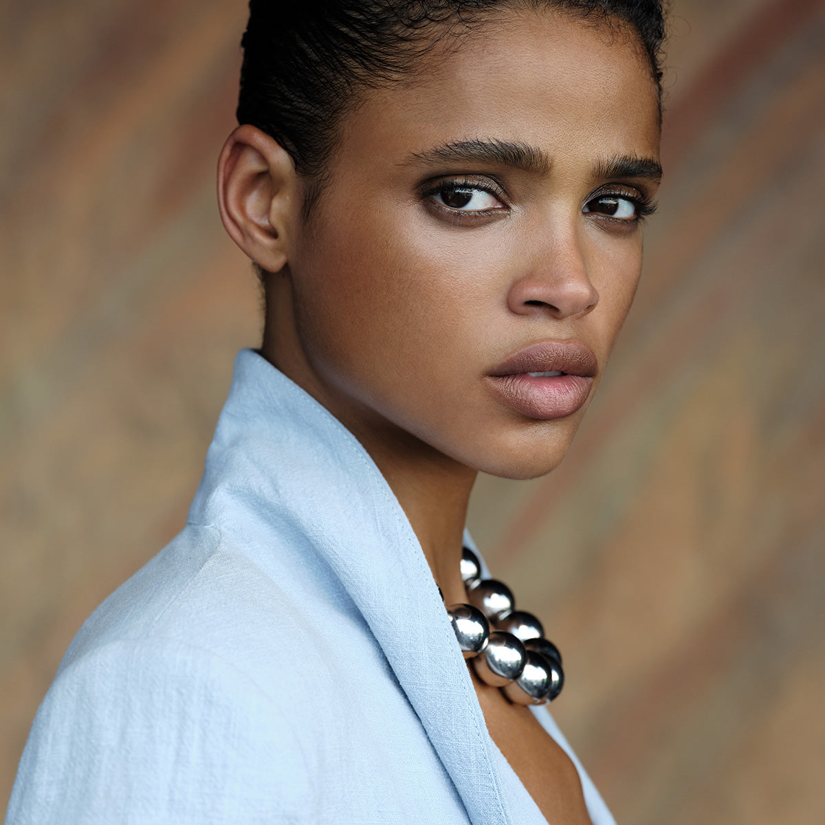 Model wearing  MoAnA LUU Maxi Beads necklace with barrel lock in silver. Inspired by Creole jewelry. 