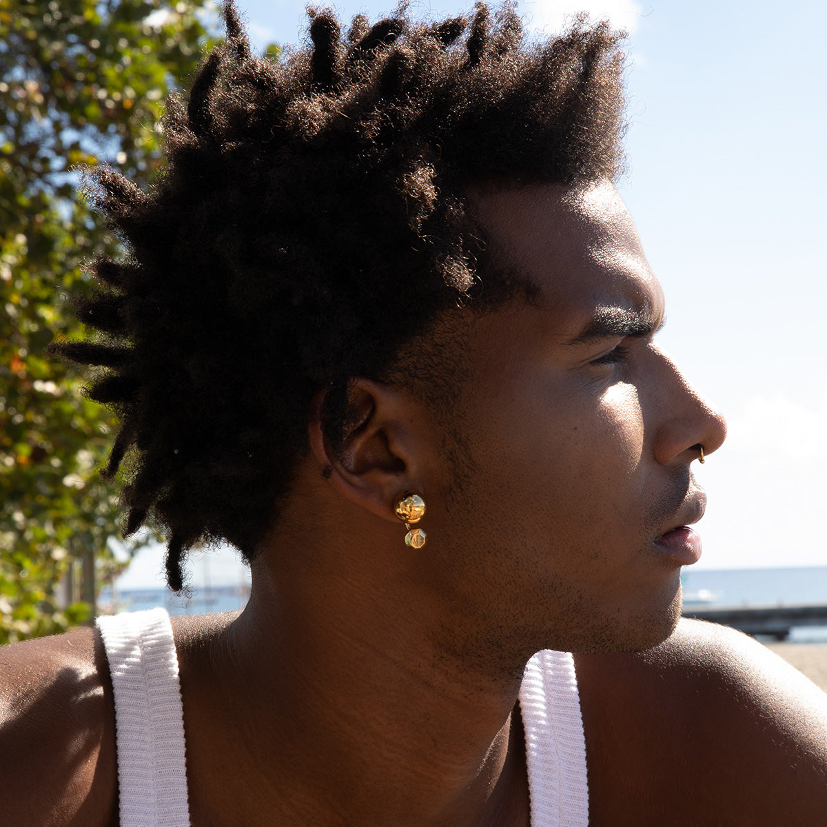 Model wearing MoAnA LUU bead earrings in vermeil. Inspired by Creole jewelry. 